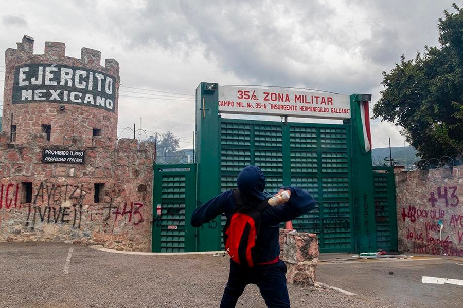 Normalistas de Ayotzinapa lanzan petardos y estampan un camión repartidor en la entrada de la 35 Zona Militar